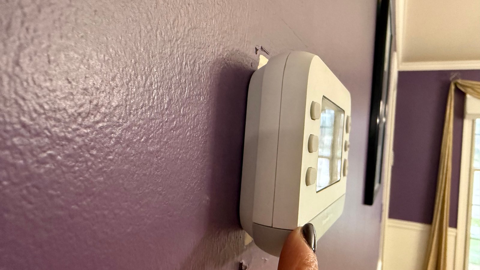 Smart thermostat on a wall in a Sutton Coldfield home — smart heating controls installed by Vulcan Heat